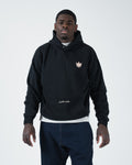 Black BJJ pullover hoodie front view on adult male model with crown logo and jiu jitsu motion script [color:Black]