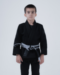Kingz Born to Rule Youth Jiu Jitsu Gi - Black - Full Body Front View Young Athlete Black Gi Gray Belt Kingz Logo Patch Left Arm Durable Stitching Youth BJJ Gi Training [color:Black]