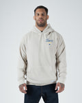 Tan BJJ Champion hoodie front view on adult male model showing blue Champion Mentality chest script [color:French Oak]