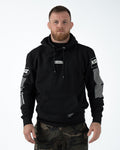 Kingz Slant Bar Pullover Hoodie Black - Full Body Front View Male Athlete Black Hoodie White KINGZ Chest Patch KG Sleeve Logos Striped Arm Design Kangaroo Pocket Streetwear Casual Apparel [color:Black]