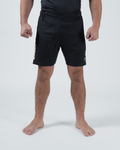 Kingz Player Special Limited Edition Shorts Black Gold - Full Body Front View Male Athlete All-Black KINGZ Gold Text Left Leg Gold Crown Badge Right Thigh Black Elastic Waistband Competition Cut Men's Grappling Shorts No-Gi BJJ Tainan Dalpra Signature Collection [color:Black]