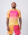 Kingz Endless Roll Rashguard Red/Orange - Full Body Front View Male Athlete Gradient Pink to Yellow Short Sleeve Speckled Pattern Logo on Sleeve Athletic Fit BJJ No-Gi Rash Guard [color:Red/Orange]
