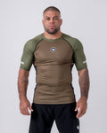 Kingz Terra Rashguard Brown Green - Front Flat Lay Product Shot Short Sleeve Brown Earthy Center Body Olive Green Raglan Sleeves Dark Navy Side Panels White Crown Logo Circle Chest KINGZ White Sleeve Text Green Collar BJJ No-Gi [color:Green/Brown]
