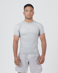 Kingz Ghost Rashguard Silver Gray - Full Body Front View Male Athlete Short Sleeve All Gray Minimal Design Subtle Crown Logo Light Gray Matching Shorts Crown Badge Compression Fit [color:Silver]