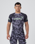 Kingz Viper Rashguard Black Purple - Full Body Front View Male Athlete Short Sleeve Hexagonal Viper Scale Camo Pattern Dark Gray Purple Neck Collar Green Crown Logo KINGZ Green Text Matching Shorts BJJ MMA [color:Black/Purple Patterned]
