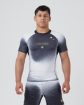 Kingz Galaxy Rash Guard Black White - Full Body Front View Male Athlete Short Sleeve Black To White Ombre Galaxy Pattern Gold Star Detail KINGZ Gold Text Crown Logo Matching Galaxy Pattern Spats BJJ MMA Training [color:Black/Galaxy]