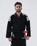 Kingz Sport Jiu Jitsu Gi - Black - Front View Male Athlete Black Gi White Shoulder Panels Crown Logo Red Belt Patch KINGZ Hem Tag Durable Stitching BJJ Training Gi