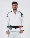 Kingz Sport Jiu Jitsu Gi - White - Front View Male Athlete Black Shoulder Panels Crown Badge Sleeves Black Belt Red Patch Kingz Logo Hem Comfortable Fit BJJ Gi Training