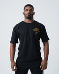 Kingz Legends Never Die Tee Black - Full Body Front View Male Athlete Black T-Shirt Gold "Legends Never Die" Text Left Chest Classic Fit Crew Neck BJJ Training Apparel [color:Black]