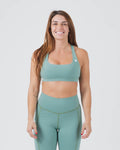 Kingz Kore Women's Sports Bra - Light Green - Front View Female Athlete White Crown Logo Left Chest Smooth Fabric Racerback Design Comfortable Fit BJJ Training MMA Fitness [color:Light Green]
