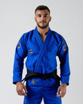 Kingz Comp 450 V6 Gi Blue - Front View Male Athlete Blue Gi Black Belt Crown Patches Shoulders Gold Text Chest Durable Weave Jiu Jitsu Gear Training Gi [color:Blue]