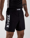 Kingz Jiu Jitsu Royalty Shorts Black - Waist Down Front View Male Athlete Bold KINGZ Vertical Text Left Thigh Elastic Waistband Logo Patch Comfortable Fit BJJ Grappling No-Gi Training