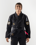Kingz Comp 450 V6 Women's Gi Black - Front View Female Athlete Black Gi Yellow Crown Patches Embroidered Logos Contrast Stitching Durable Weave BJJ Gi Training Competition [color:Black]